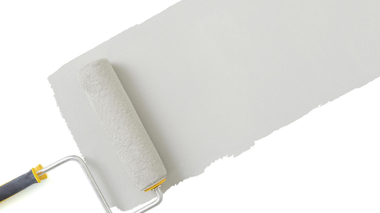 A paint roller applies grey paint to a white wall.